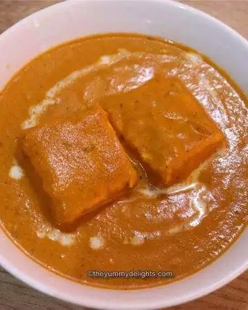 Shahi paneer served in a white bowl.