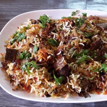 close-up of hyderabadi mutton biryani served on a plate.