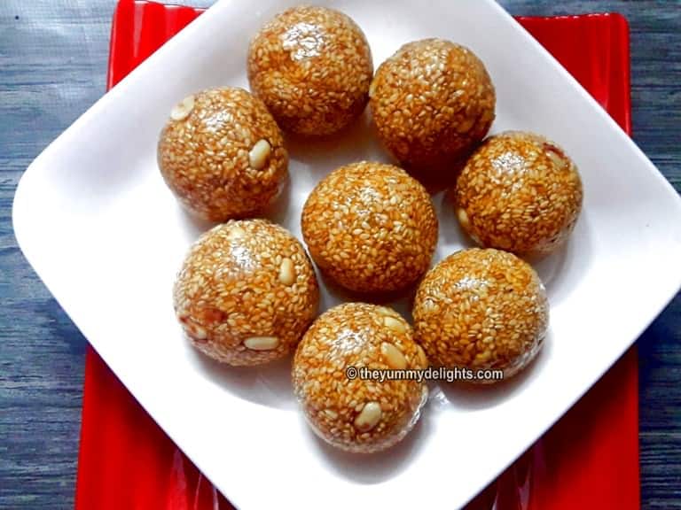 Close up of til ladoo served on a white plate.