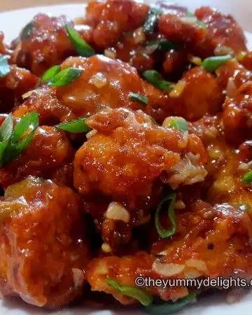 close up of gobi manchurian garnished with spring onion greens.