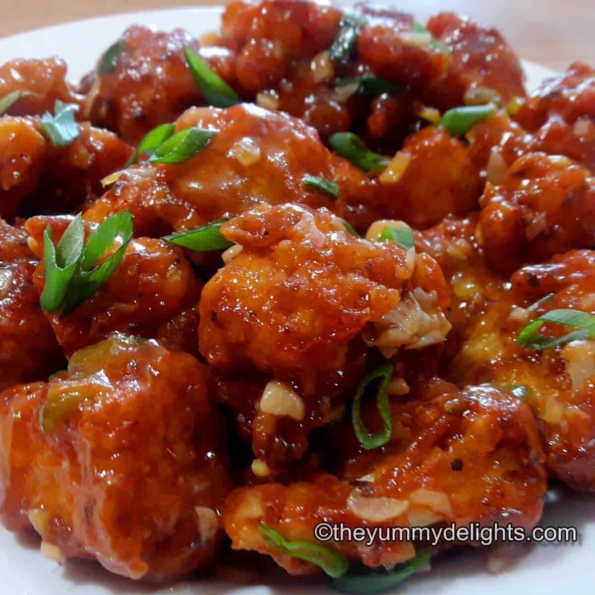 close up of gobi manchurian garnished with spring onion greens.