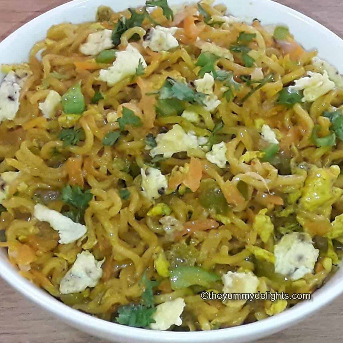 close up of egg maggi served in a whie bowl.