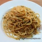spaghetti aglio, olio e peperoncino served in a white plate.