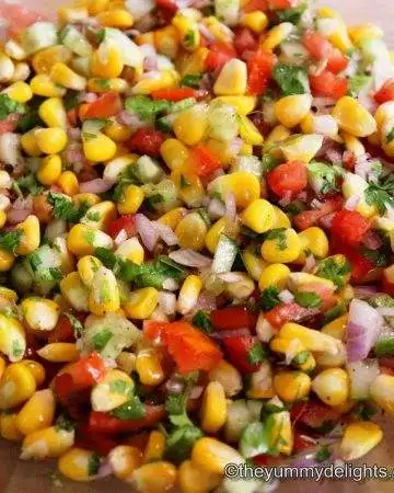 Close up of corn salsa in a mixing bowl.