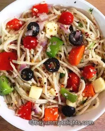 spaghetti salad served in a white bowl.