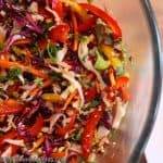 Close-up image of crunchy asian slaw in a mixing bowl.