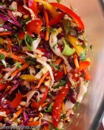 Close-up image of crunchy asian slaw in a mixing bowl.