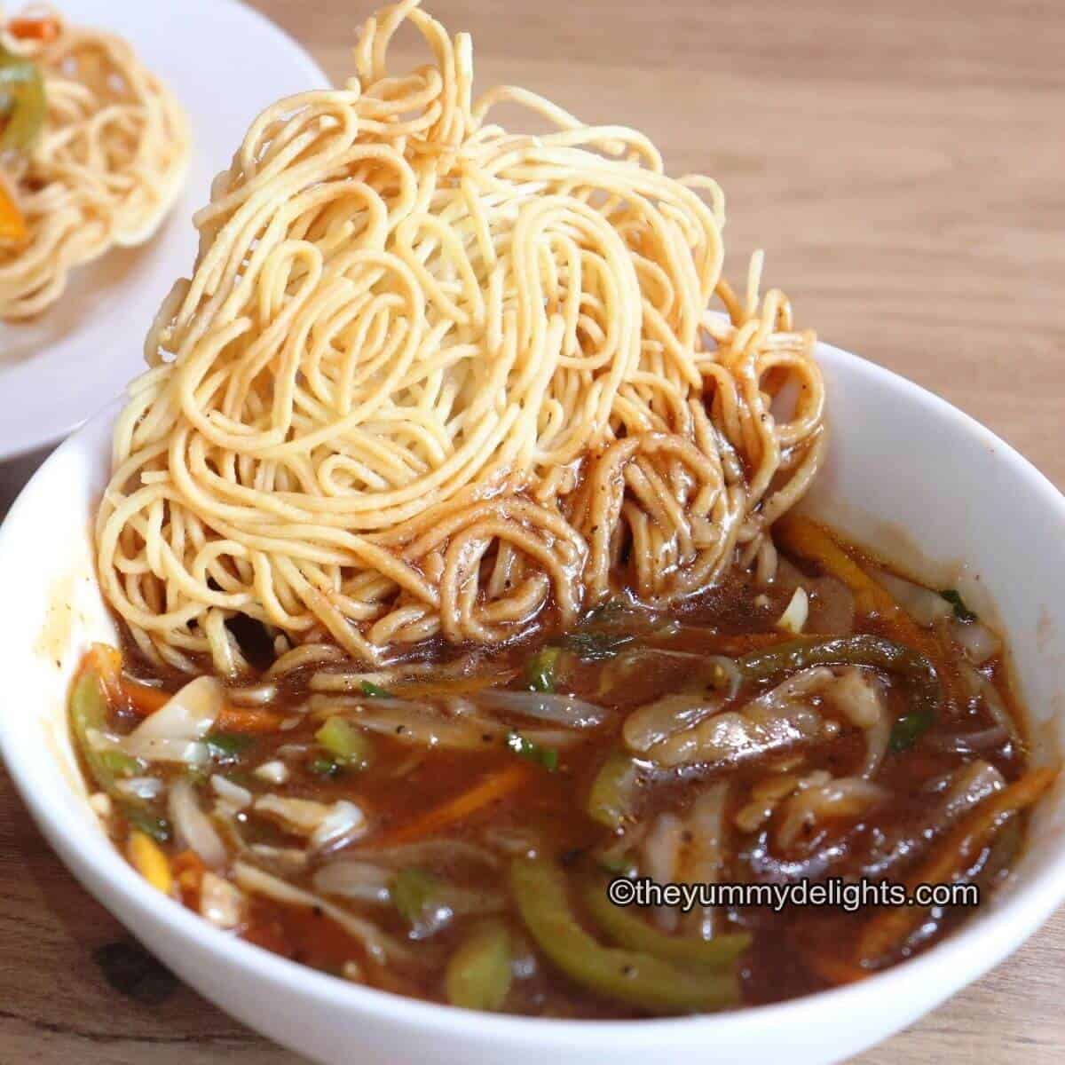 close-up image of veg American chop suey served in a white bowl.