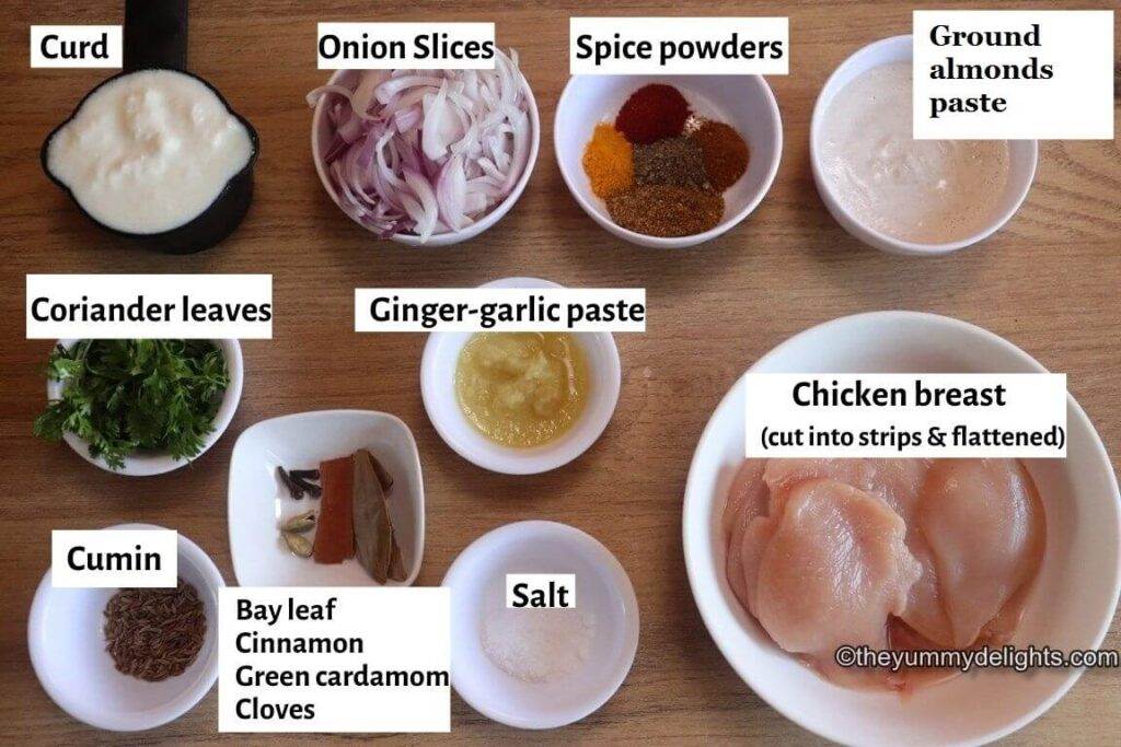 individually labeled ingredients to make chicken pasanda recipe are laid out on a table.