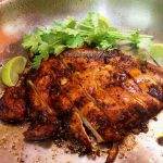lime cilantro chicken in a pan. This Mexican lime chicken is garnished with cilantro leaves and lime wedges.