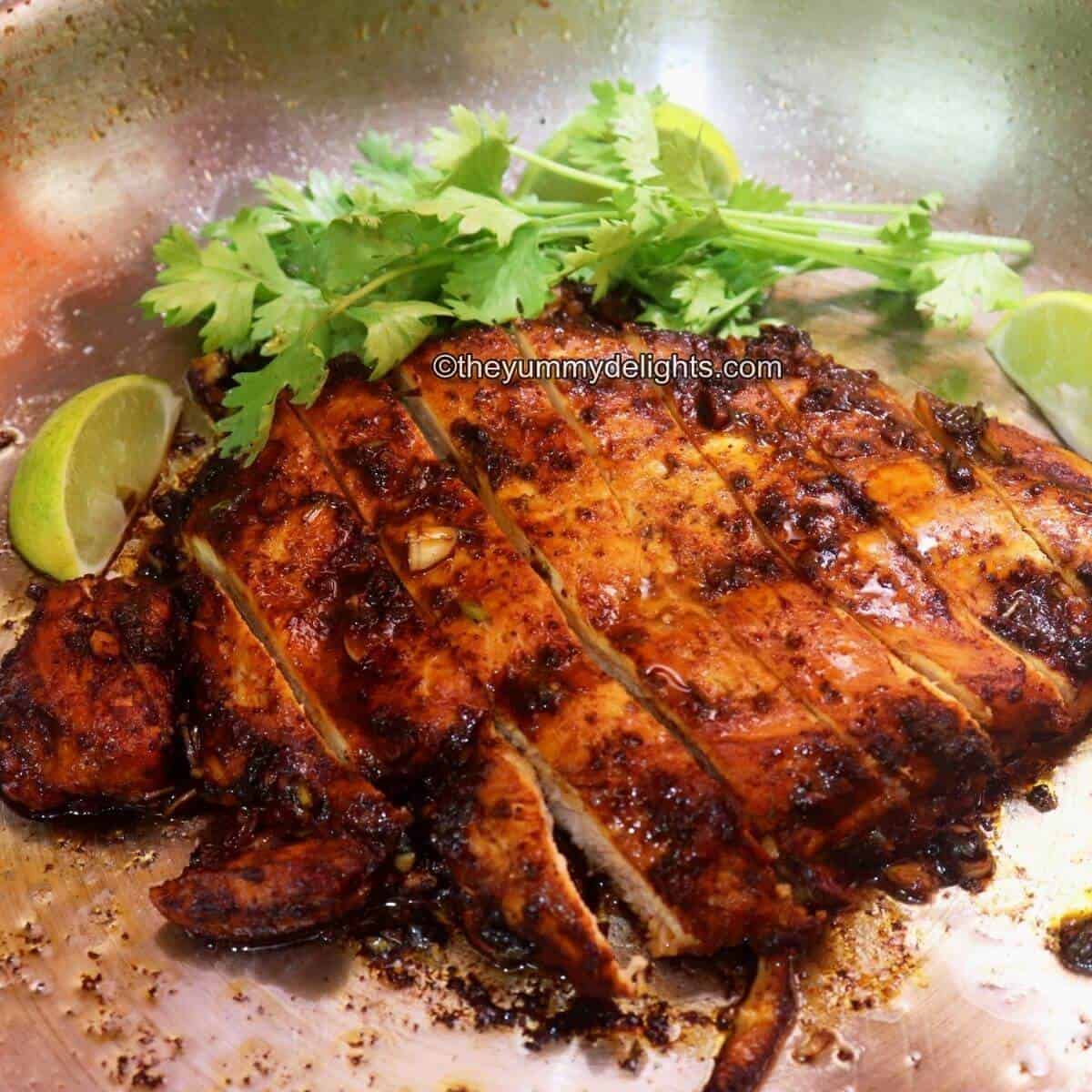 lime cilantro chicken in a pan. This Mexican lime chicken is garnished with cilantro leaves and lime wedges.