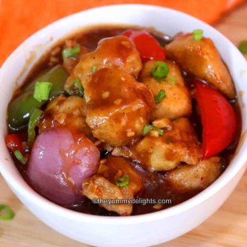 close-up of chicken manchurian gravy served in a white bowl.