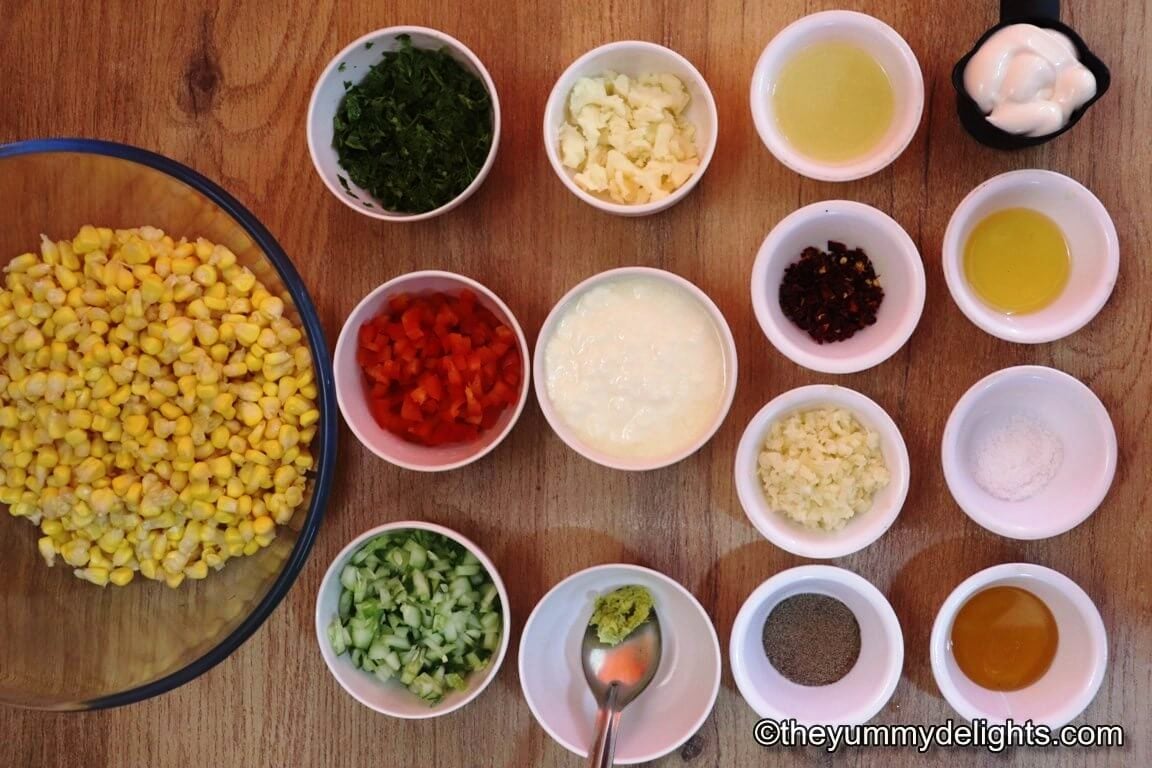 ingredients to make creamy corn salad are laid out on a table.