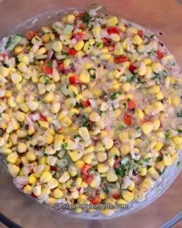 creamy corn salad in a glass bowl.