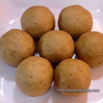 close-up of 5 peanut ladoos placed on a white plate.