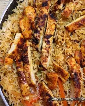 side view of chicken fajita rice in a skillet.