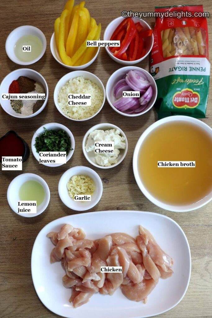 ingredients to make creamy cajun chicken pasta laid on a table.