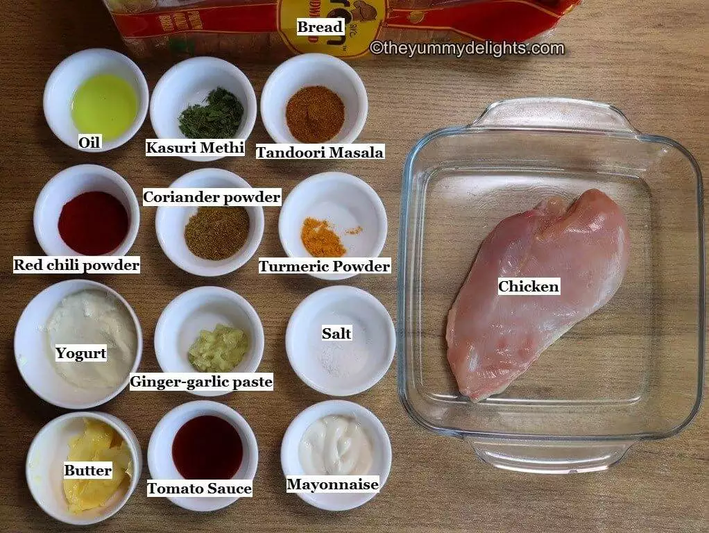 image of individual ingredients to make tandoori chicken sandwich are laid out on a table.