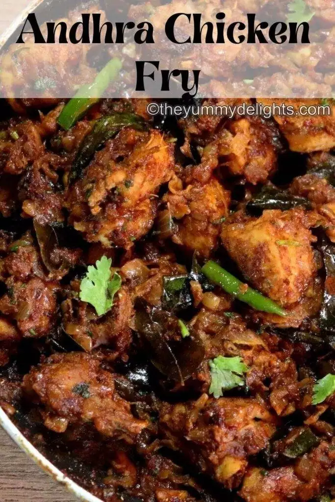 side view of Andhra chicken vepudu in a pan. Garnished with curry leaves.