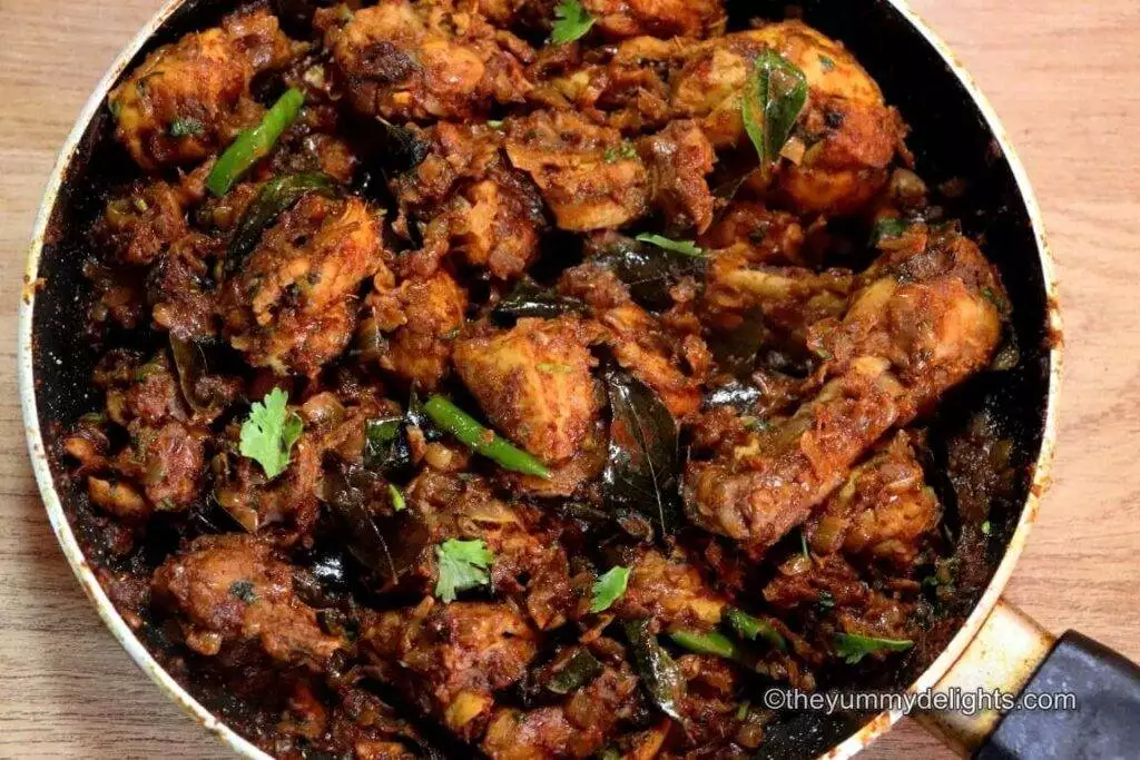 close-up image of Andhra chicken fry in a black granite pan.