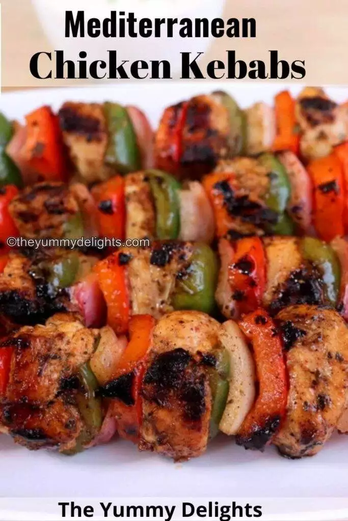 close-up of grilled mediterranean chicken kebabs on skewers.