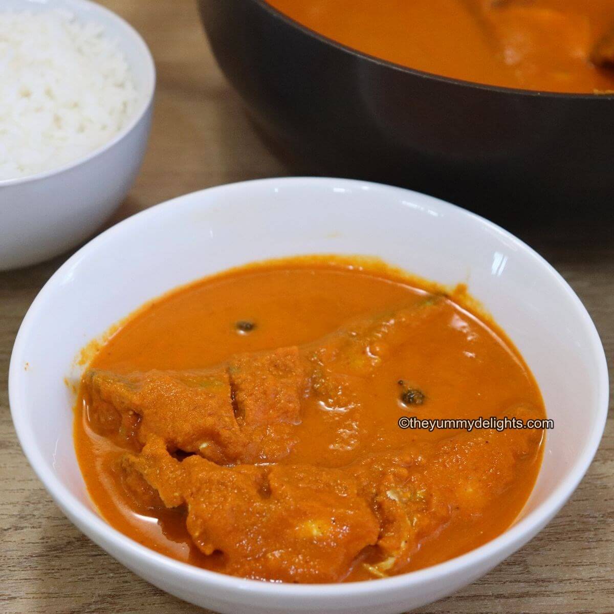 goan fish curry served in a white bowl.