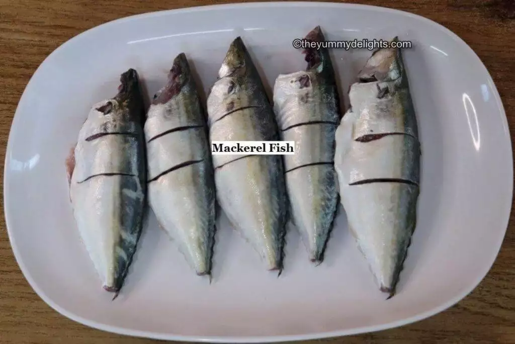 image of 5 mackerel fish on a white plate.