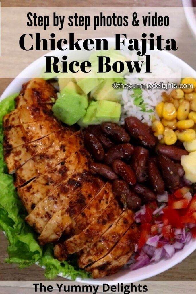 Close-up of chicken fajita rice bowl. It shows fajita bowl with rice as base and topped with lettuce leaves, chicken, avocado, corn, beans, salsa and cheese.