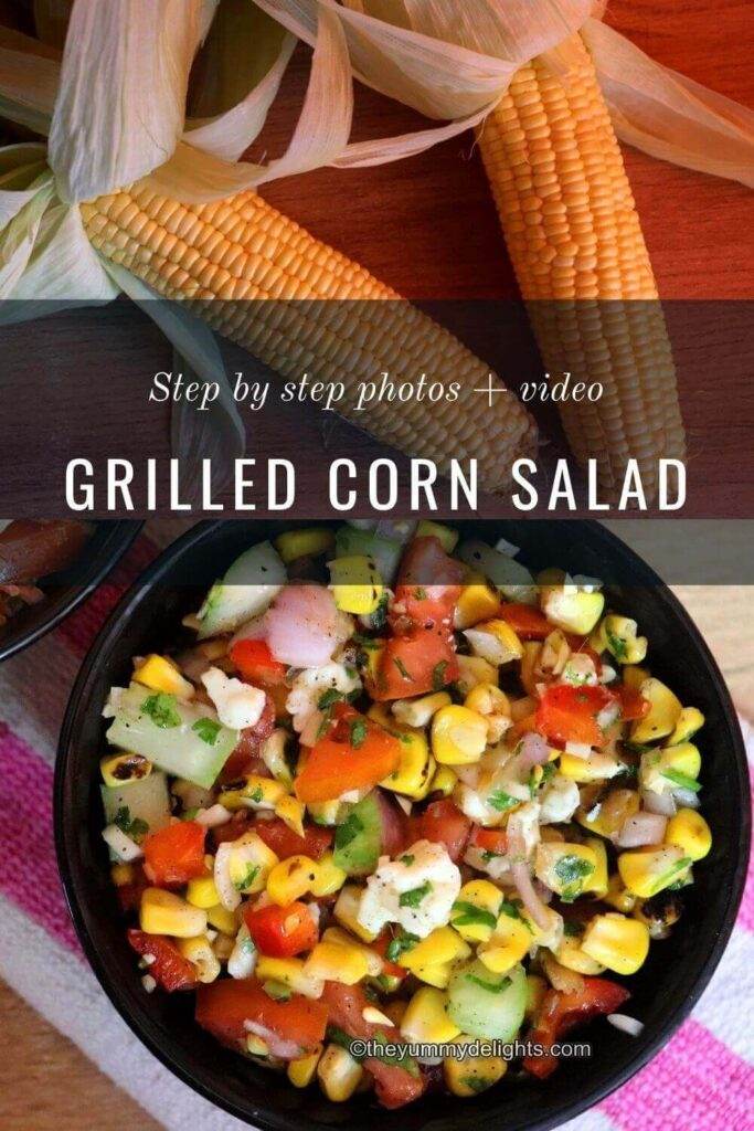 Overhead view of grilled corn salad with feta cheese served in a black colored bowl. You can also see 2 corn on cob placed on the side.