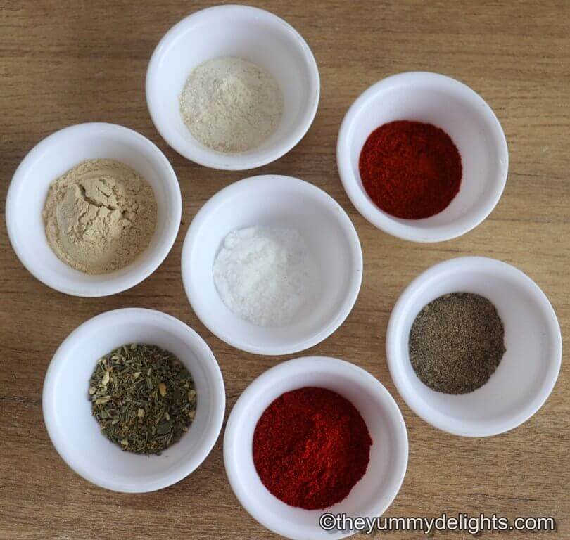 ingredients to make cajun chicken seasoning laid out on a table.