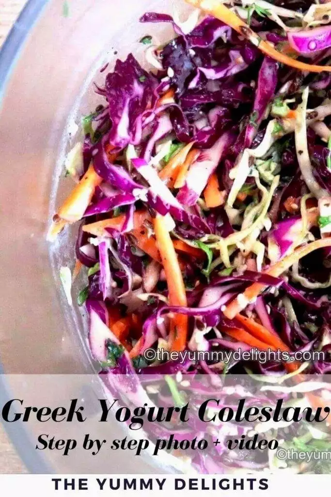 Side view of Greek yogurt coleslaw in a large glass bowl. You can see colorful cabbage, carrots and cilantro. Garnished with roasted sesame seeds and flax seeds.