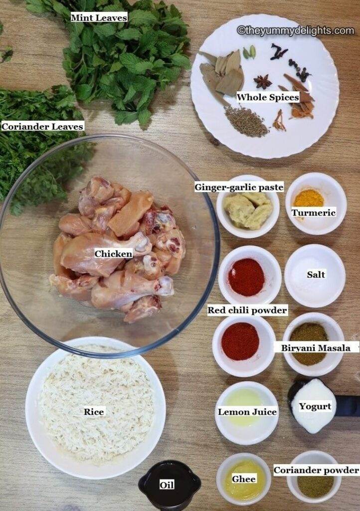 individually labeled ingredients to make pressure cooker chicken biryani laid out on a table.