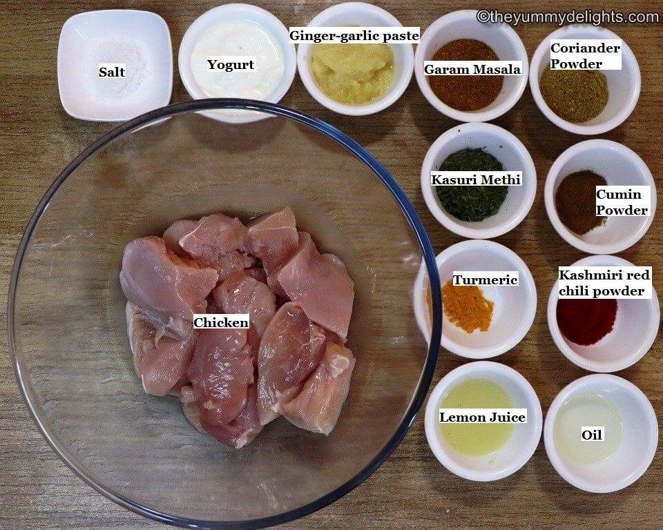 Individually labeled ingredients to marinate chicken for making Indian butter chicken recipe are laid out on a table.