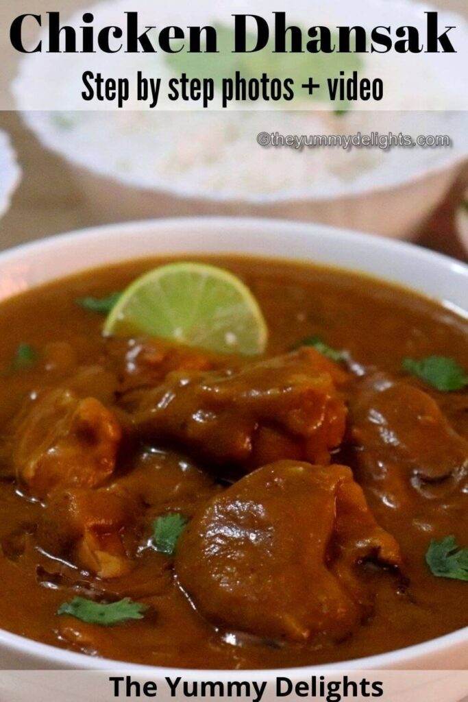 close-up of chicken dhansak served in a white bowl with a lemon wedge over it. Garnished with cilantro and served with a bowl full of rice on the side.