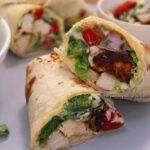 close-up of mediterranean chicken wrap. sliced and stacked over each other.