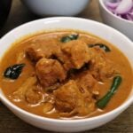 close-up of ceylon chicken curry in a white colored bowl.