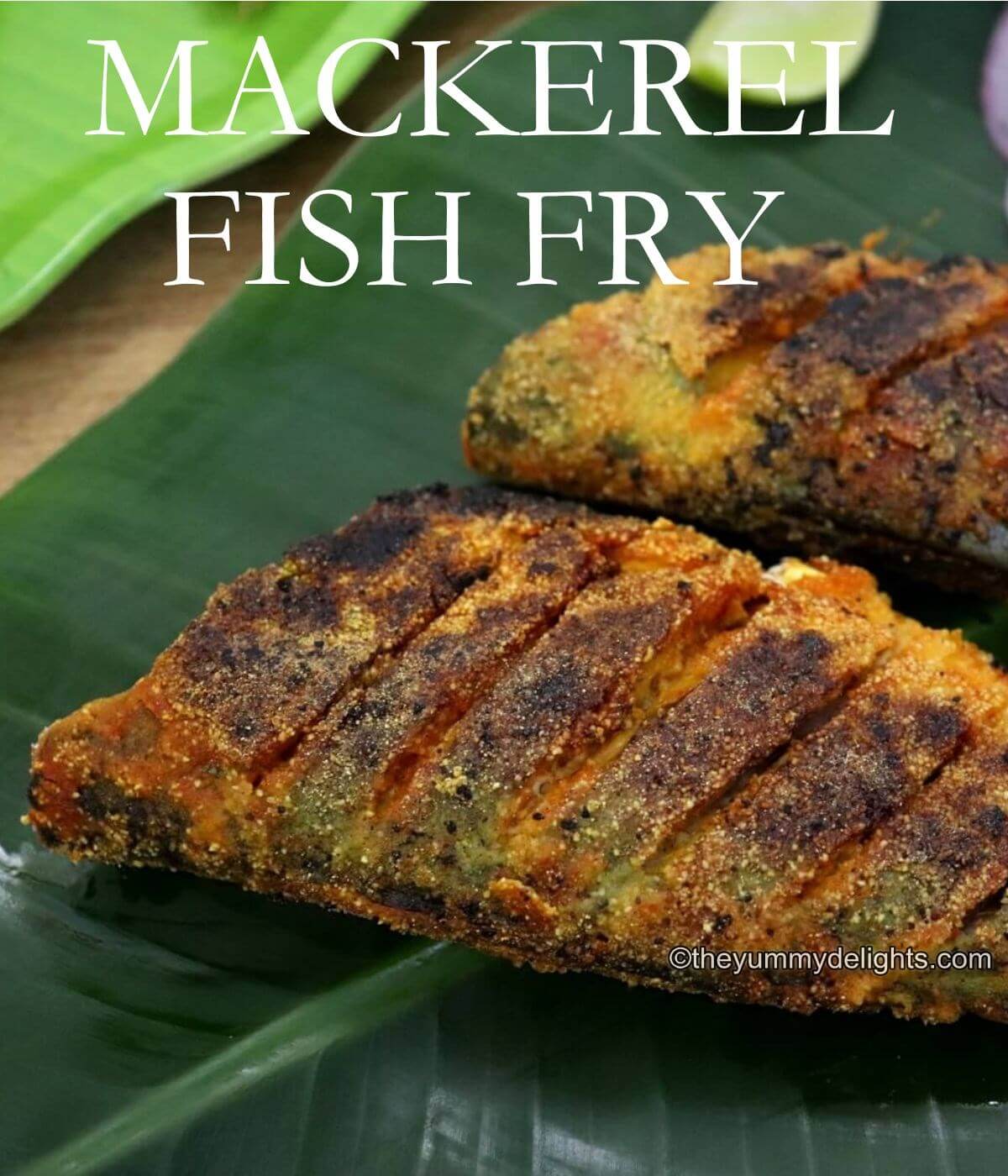 close-up of mackerel fish fry. Two fried mackerel fishes are placed next to each other on a banana leaf.