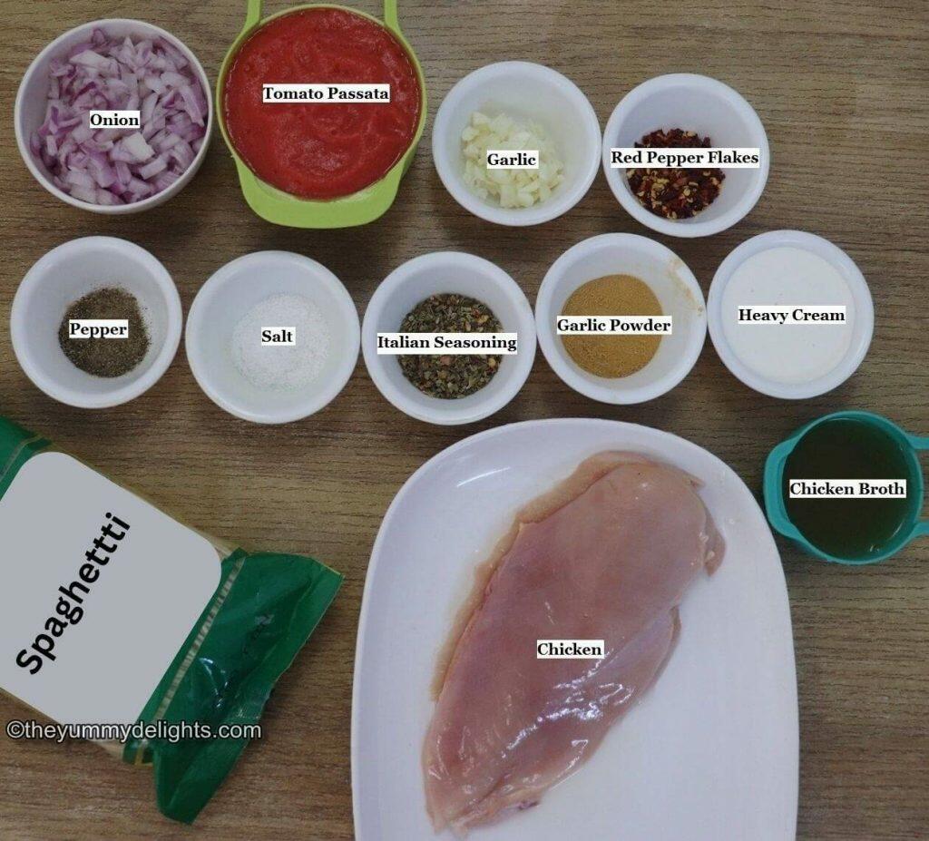 individually labeled ingredients to make spicy chicken spaghetti are laid out on a table.
