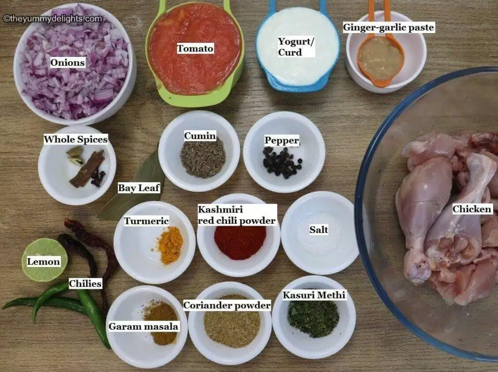 individually labeled ingredients to make dhaba style chicken curry recipe are laid out on a table.