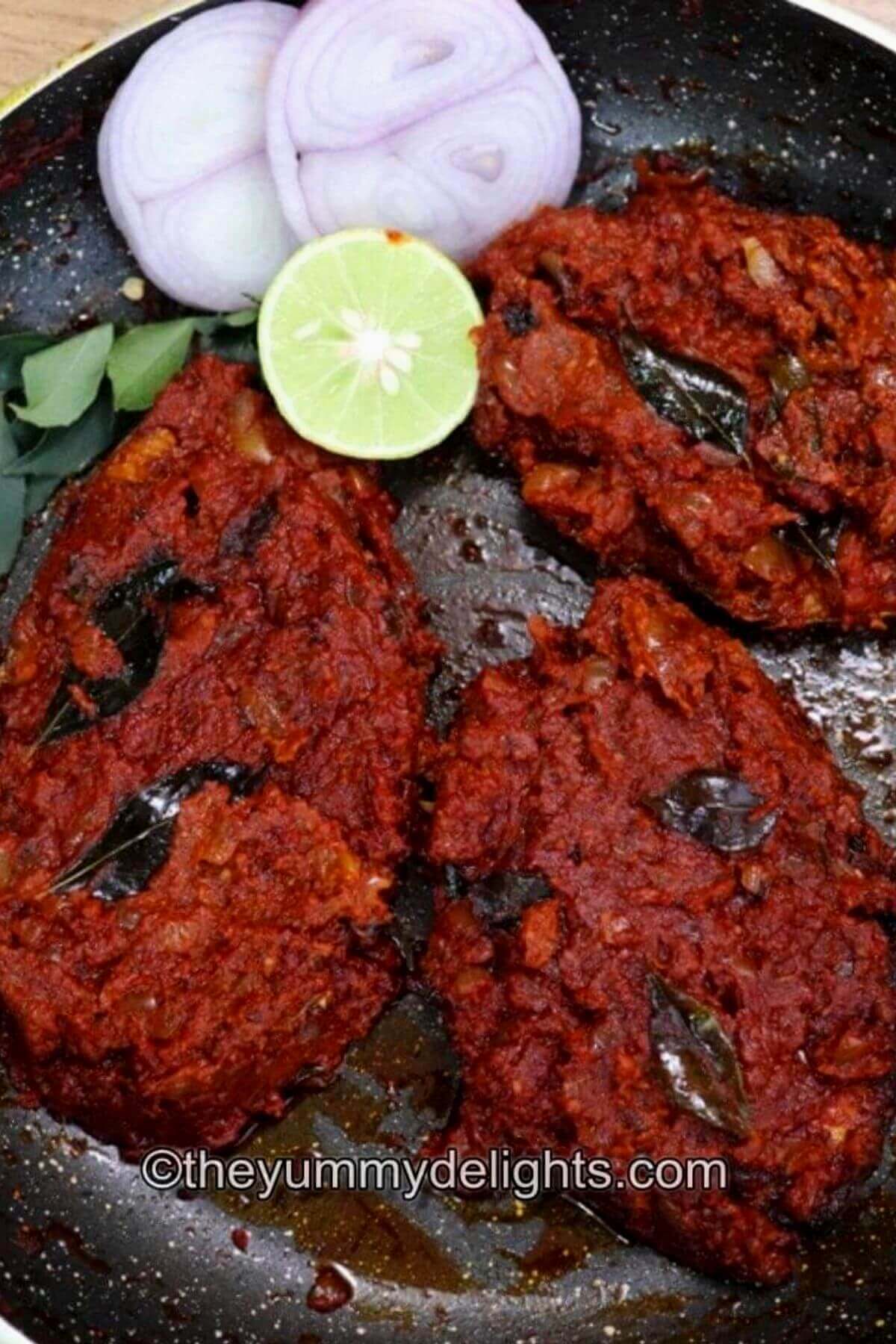 close-up of fish masala fry in a black colored pan.
