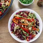 close-up of Asian slaw served in a white bowl.