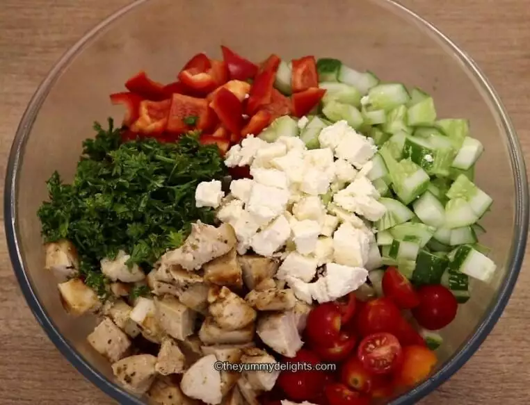 shows assembling the greek chicken pasta salad.