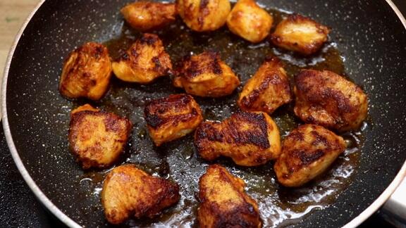 pan-frying the chicken to make cajun chicken and rice skillet.