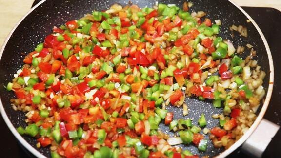 sauteing vegetables to make one pot chicken and rice.
