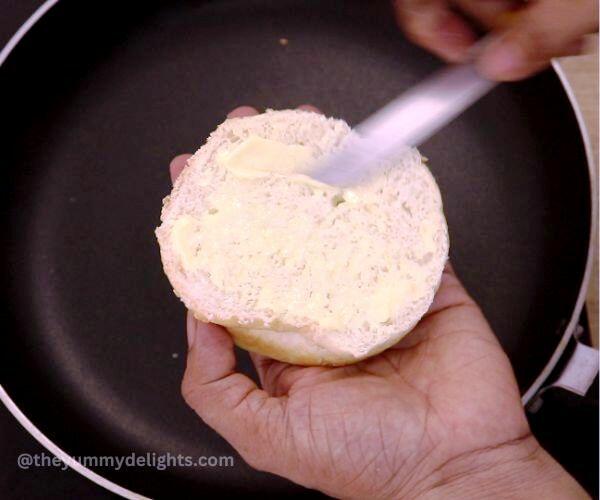 applying butter over bun.