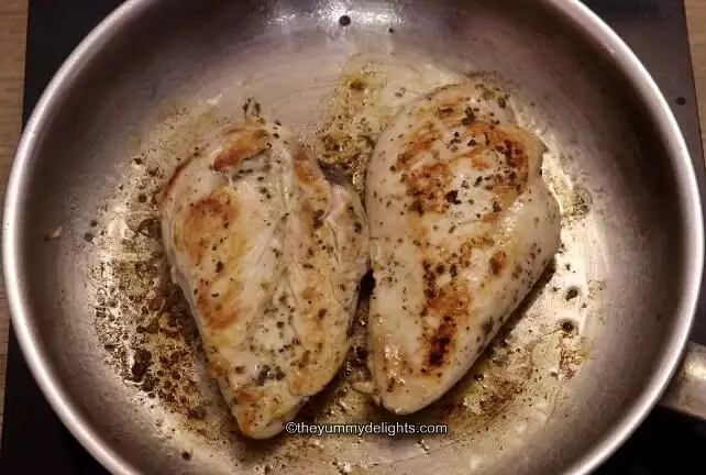 cooked chicken in a skillet to make greek chicken pasta salad.