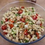 Greek chicken pasta salad in a serving bowl.