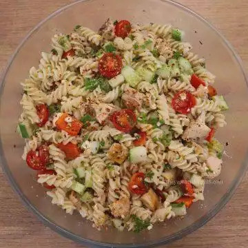Greek chicken pasta salad in a serving bowl.