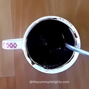 addition of wet ingredients to the mug to make chocolate mug cake recipe.