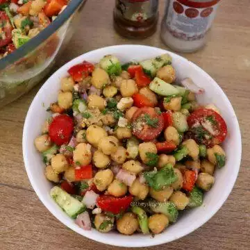 close-up od mediterranean chickpea salad in a white colored bowl.